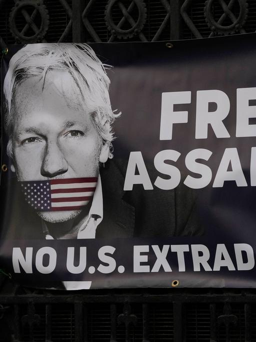 Ein Banner mit einem Foto von Julian Assange und der Aufschrift: "Free Assange" und "No U.S Extradition". 