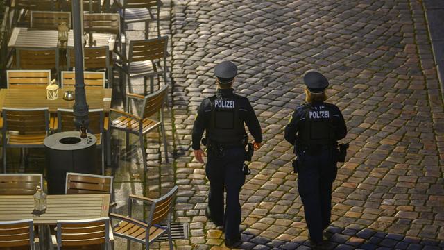 Polizisten laufen am Abend in der Dresdner Altstadt an Restaurants entlang. Die Polizeidirektion Dresden kontrolliert die Einhaltung der neuen Corona-Regeln täglich mit 50 Beamtinnen und Beamten. Im Fokus stehen demnach Kontrollen der FFP2-Maskenpflicht im öffentlichen Nahverkehr sowie die Ausgangsbeschränkungen für Ungeimpfte in Hotspot-Gebieten.