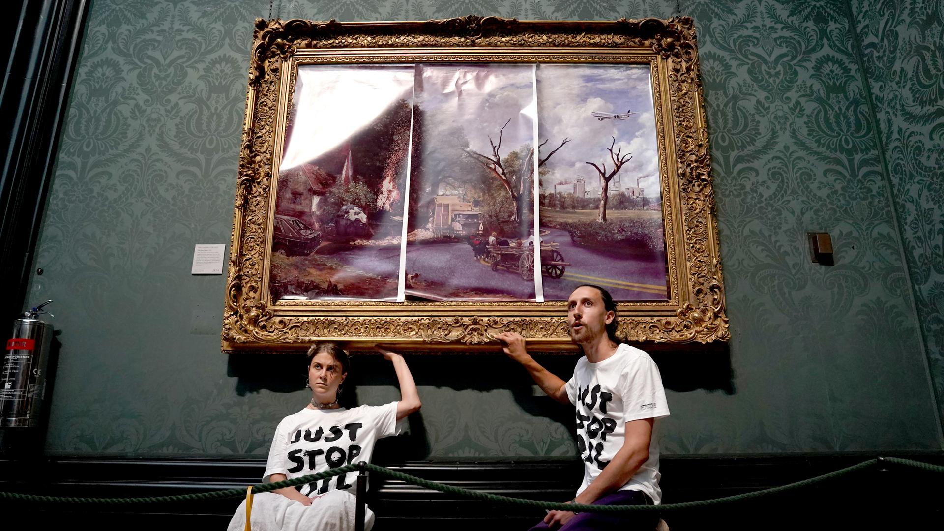 Demonstrierende der Klimaprotestgruppe "Just Stop Oil" kleben ihre Hände auf den Rahmen von John Constables Werk "The Hay Wain". Demonstrierende der Klimaprotestgruppe "Just Stop Oil" kleben ihre Hände auf den Rahmen von John Constables Werk "The Hay Wain".