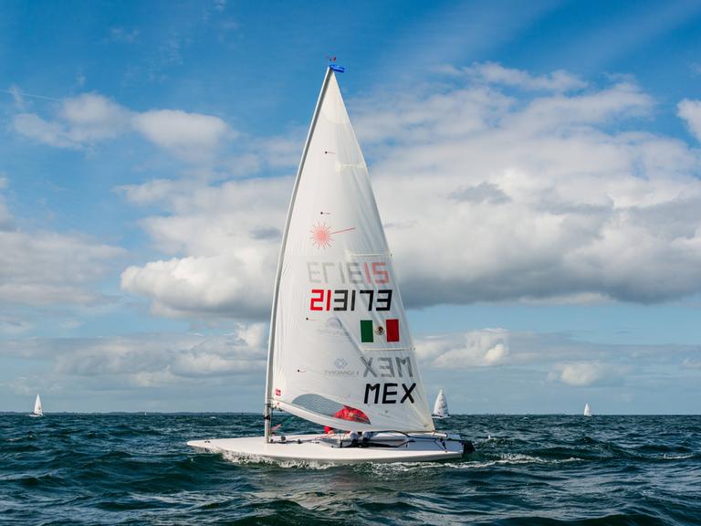 Ein kleines Segelboot mit einem Segelmast auf dem Meer während einer Regatta.