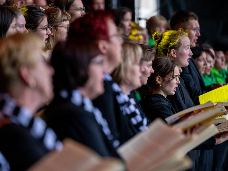 Sängerinnen und Sänger des Kammerchores Chemnitz, des Landesjugendchores Sachsen und der Singgemeinschaft Großenhain treten zum Abschluss des Deutschen Chorfests 2022 auf dem Markt in Leipzig auf.