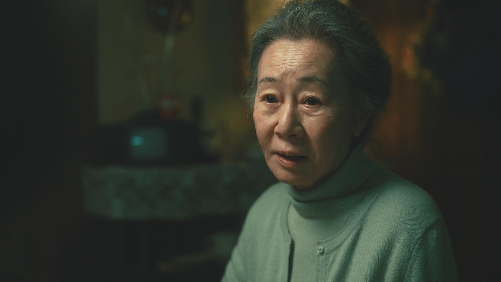 Szene aus der Serie "Pachinko". Zu sehen ist eine ältere asiatische Frau. Szene aus der Serie "Pachinko". Zu sehen ist eine ältere asiatische Frau.