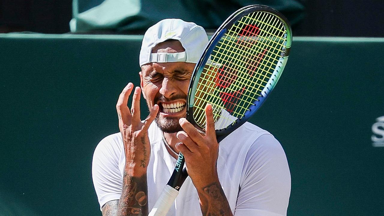 Tennisprofi Nick Kyrgios kneift mit Schläger in der Hand auf dem Tennisplatz die Augen zusammen Tennisprofi Nick Kyrgios kneift mit Schläger in der Hand auf dem Tennisplatz die Augen zusammen