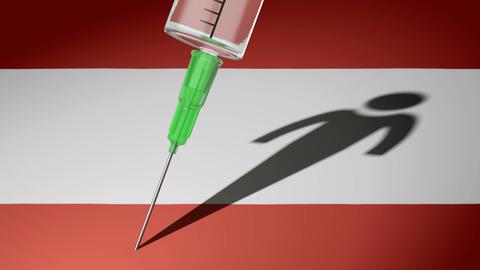 Eine Spritze sticht auf eine österreichischen Flagge, als Symbol für die künftige Impfpflicht des Landes