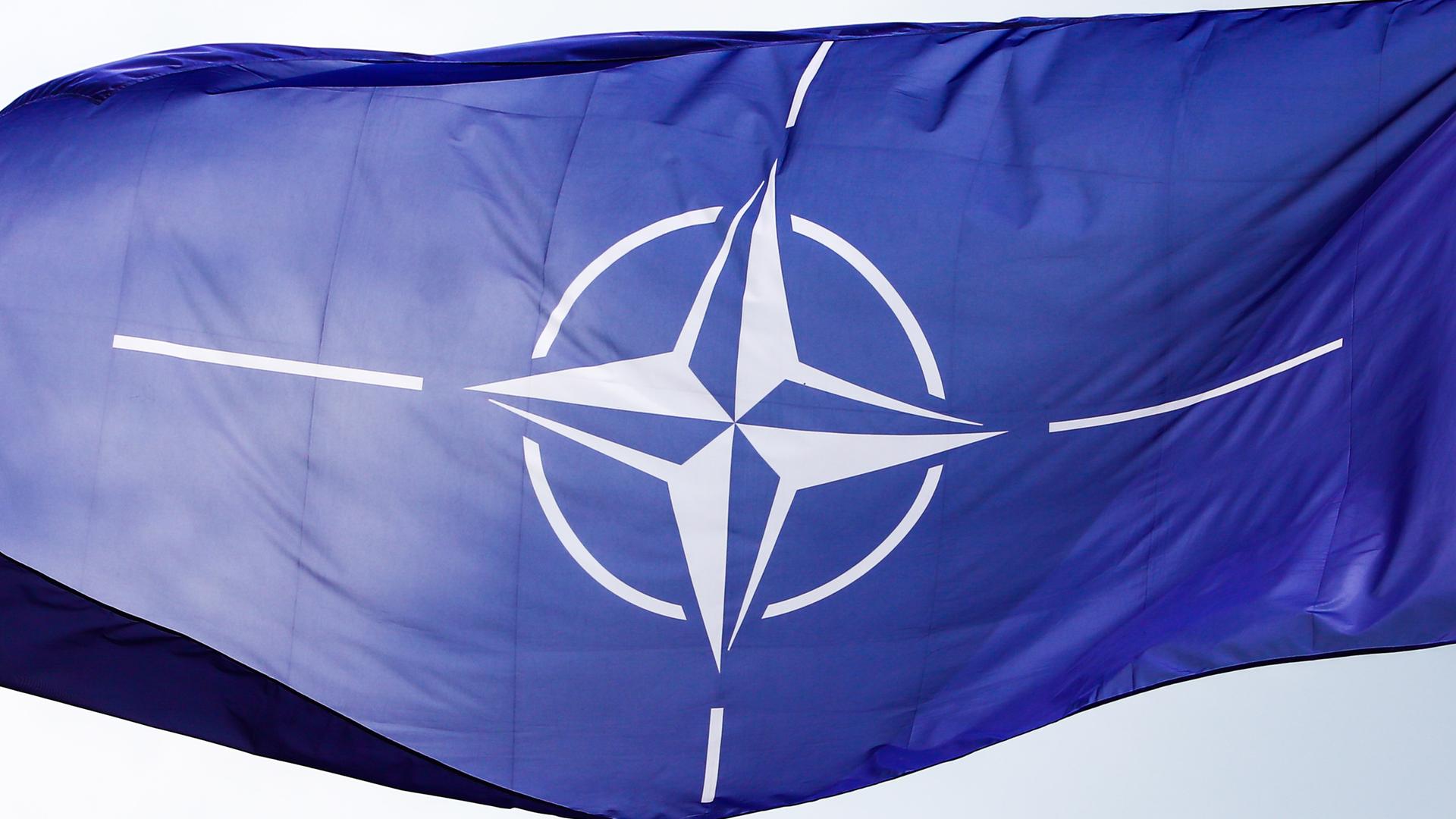 Eine NATO-Flagge weht im Wind. 