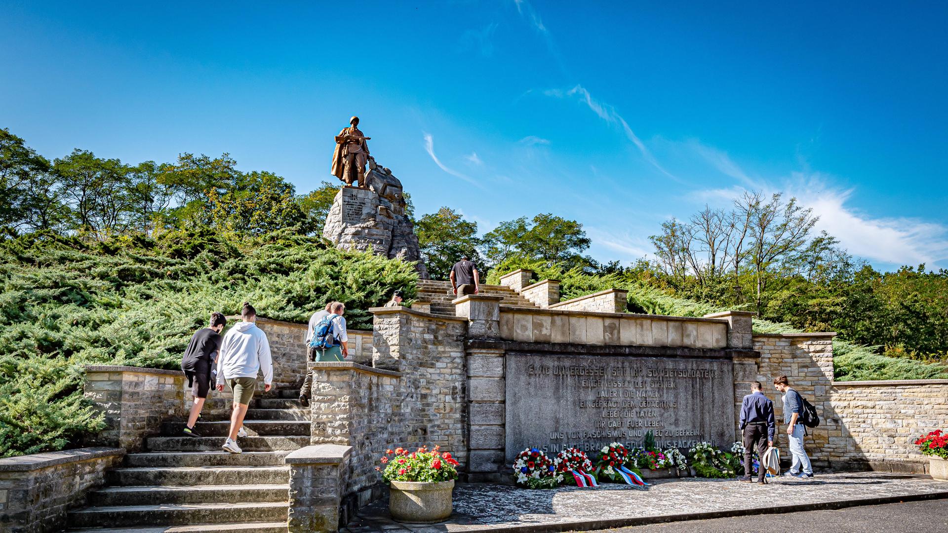 Jugendliche Besucherinnen und Besucher steigen eine Treppe in der Gedenkstätte und Museum Seelower Höhen hoch. Im Hintegrund ist das Hauptdenkmal zu sehen: Die monumentale Statue eines Sowjetsoldaten, der in die Ferne blickt. Seelow befindet sich im Bundesland Brandenburg am Rand es Oderbruchs: Jugendliche Besucherinnen und Besucher steigen eine Treppe in der Gedenkstätte und Museum Seelower Höhen hoch. Im Hintegrund ist das Hauptdenkmal zu sehen: Die monumentale Statue eines Sowjetsoldaten, der in die Ferne blickt. Seelow befindet sich im Bundesland Brandenburg am Rand es Oderbruchs: