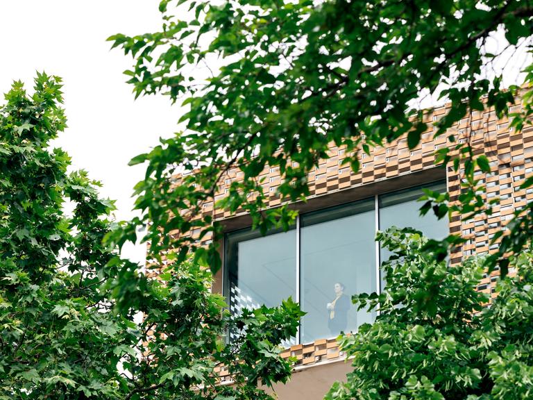 Die Ehrlichs haben sich ihr Traumhaus gebaut – es gibt Komplikationen. Zu sehen: Bäume im Vordergrund, dahinter der Teil eines modernen Hauses mit großen Fenstern.