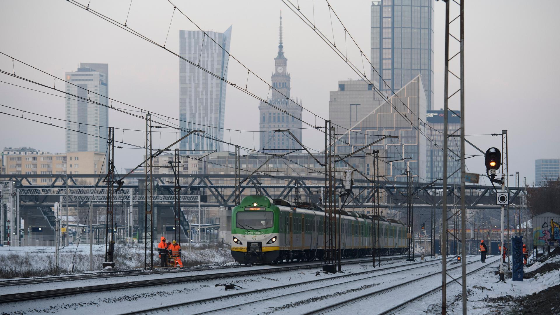 Die Skyline der polnischen Hauptstadt Warschau und davor Bahngleise mit einem Zug. Die Skyline der polnischen Hauptstadt Warschau und davor Bahngleise mit einem Zug.