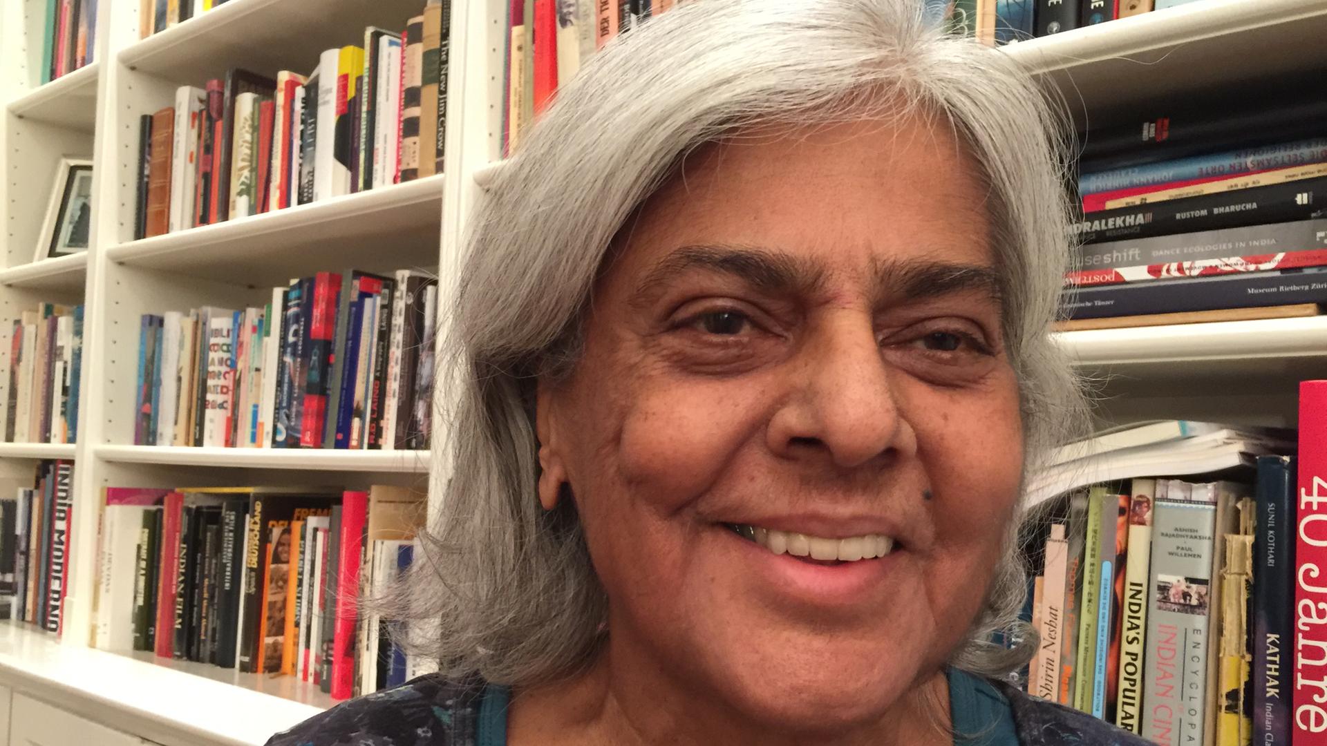 Portrait der Journalistin Navina Sundaram vor einem Bücherregal Portrait der Journalistin Navina Sundaram vor einem Bücherregal
