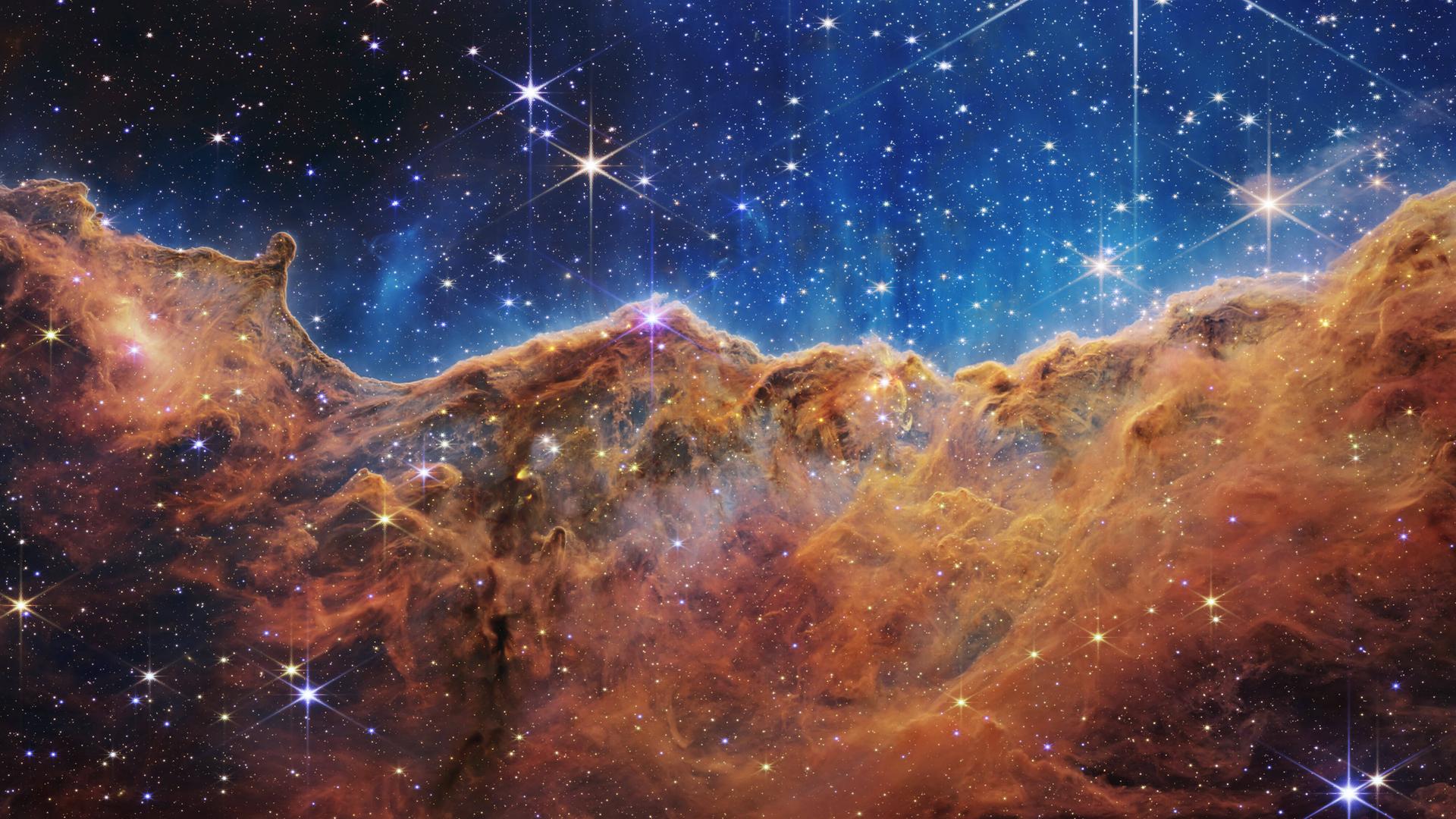 Das Foto zeigt ein Bild aus dem Welt-All in blau und orange. Das Foto zeigt ein Bild aus dem Welt-All in blau und orange.