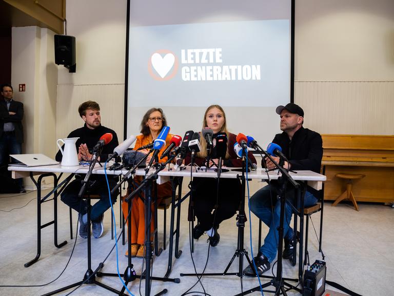 Bei einer Pressekonferenz sitzen zwei Männer und zwei Frauen an einem Tisch