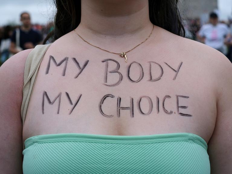"My body my choice" steht auf dem Dekolleté einer jungen Frau bei einem Protest für das Recht auf Abtreibungen in Washington DC in den USA, 2022.