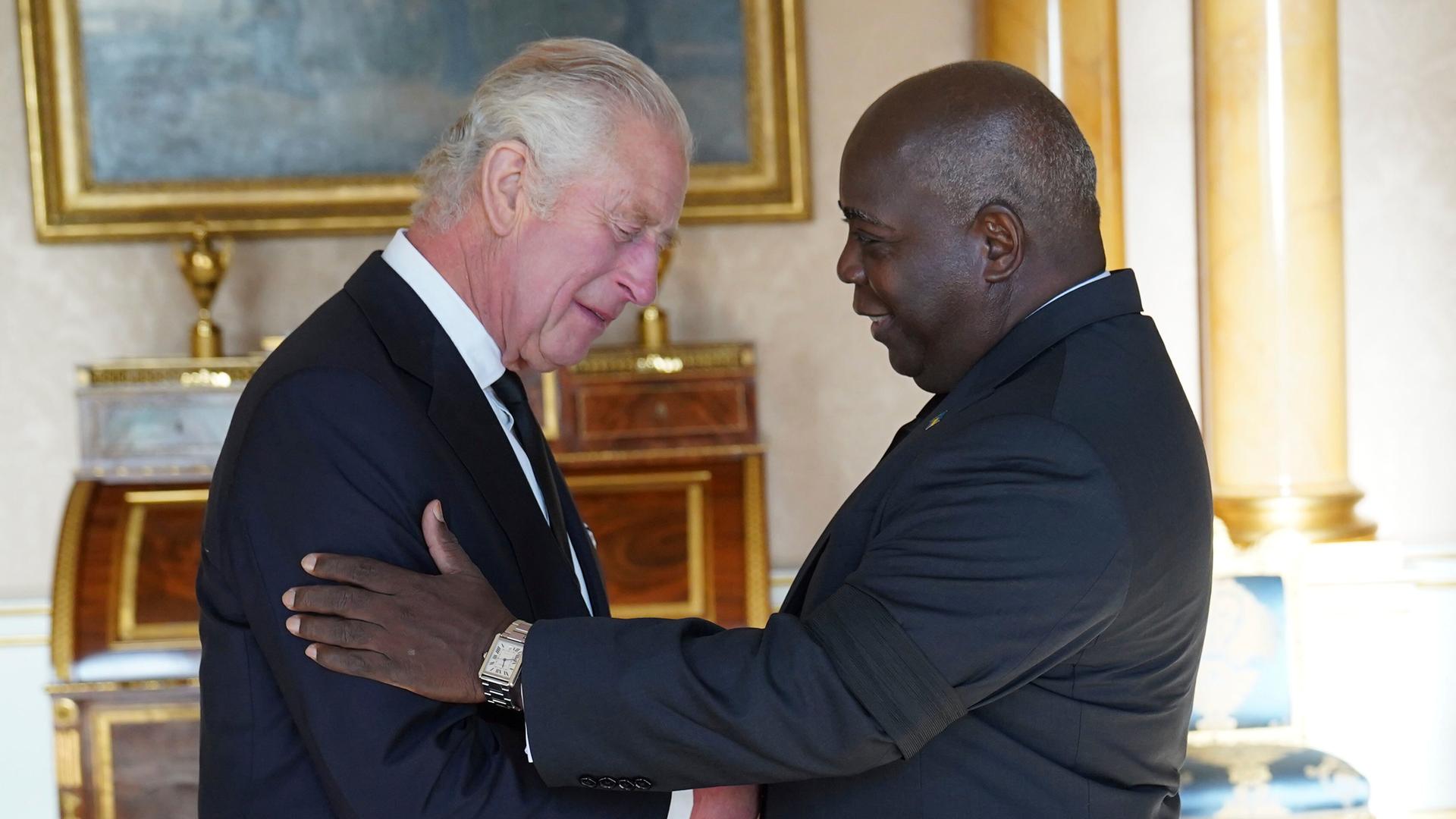 The Prime Minister Of The Bahamas, Philip Davis, A Black Man, Gives King Charles Iii.  Hand And Put The Other Hand On His Upper Arm.
