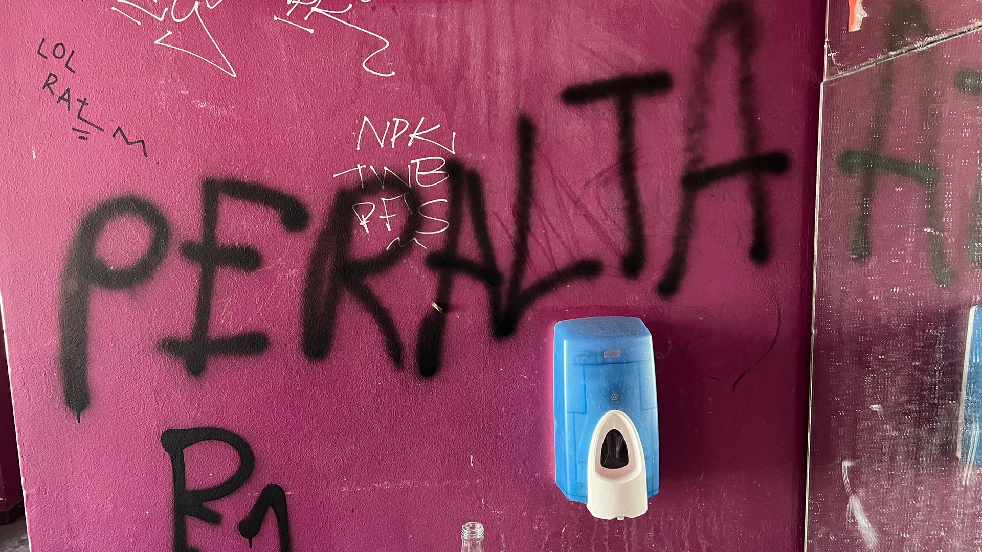 An einer Wand steht gesprüht: Peralta. An einer Wand steht gesprüht: Peralta.