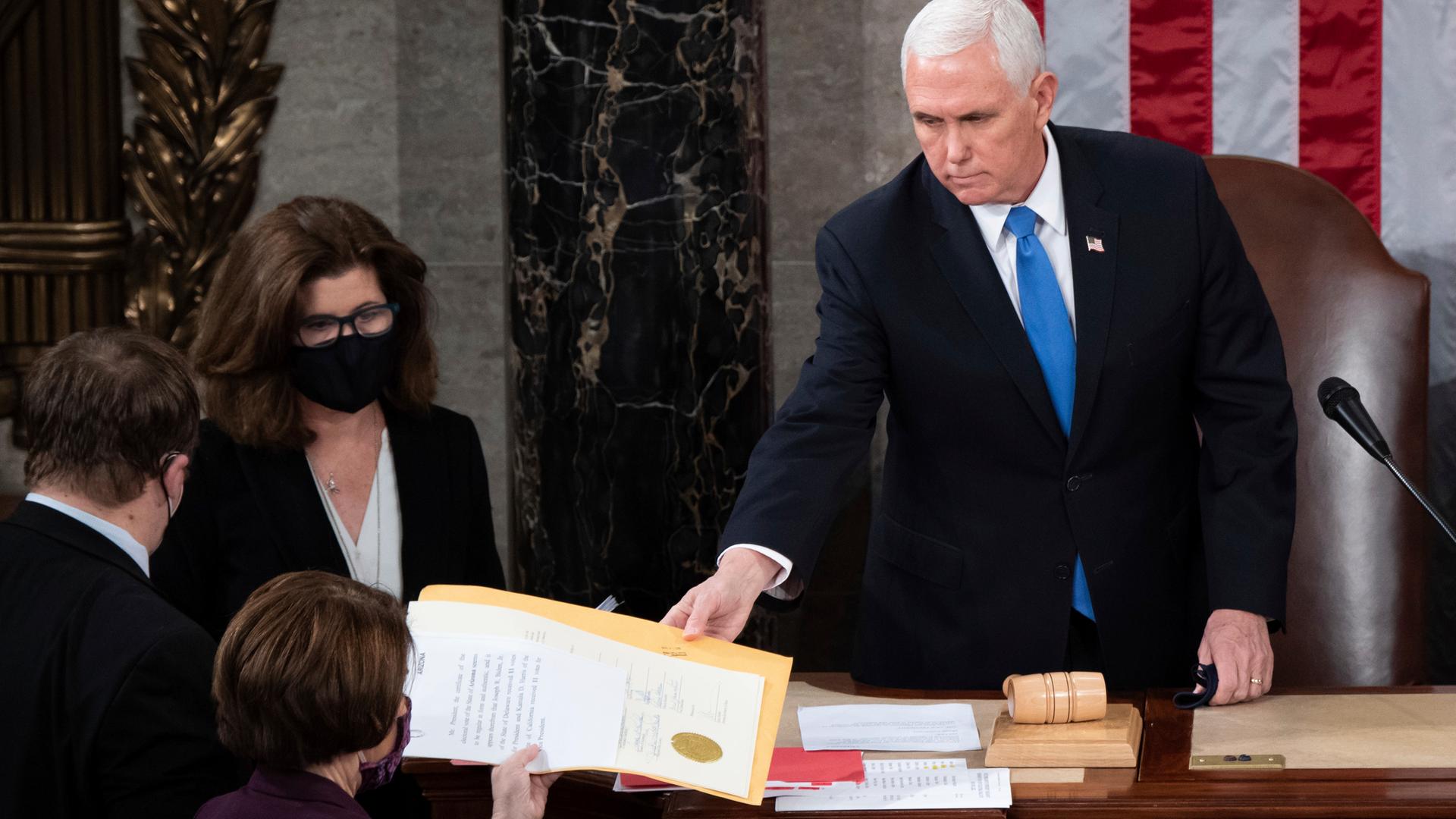 Vize-Präsident Mike Pence überreicht am 6. Januar 2021 die Wahlurkunde des Staates Arizona weiter. Vize-Präsident Mike Pence überreicht am 6. Januar 2021 die Wahlurkunde des Staates Arizona weiter.