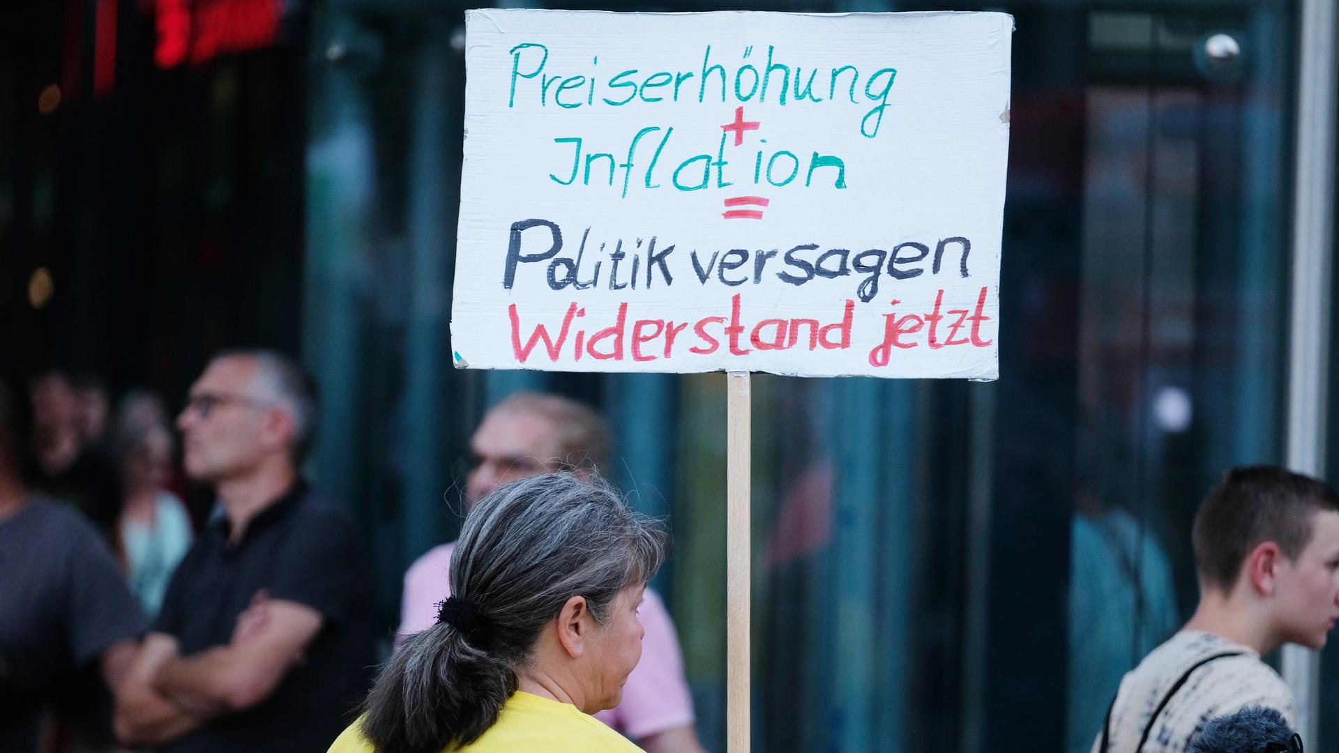 Eine Teilnehmerin einer Demonstration mit der rechten Kleinpartei "Freie Sachsen" gegen die Energie- und Sozialpolitik der Bundesregierung trägt ein Schild mit der Aufschrift "Preiserhöhung+Inflation = Politikversagen Widerstand jetzt".