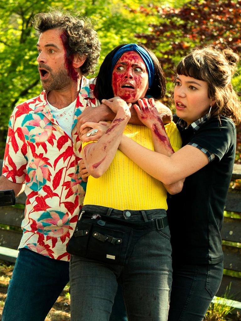 Szene aus dem Eröffnungsfilm der Filmfestspiele von Cannes zeigt eine Gruppe von 3 Personen blutüberströmt und mit erschrockenen Gesichtern. Ein Mann hält eine Kamera in der Hand.