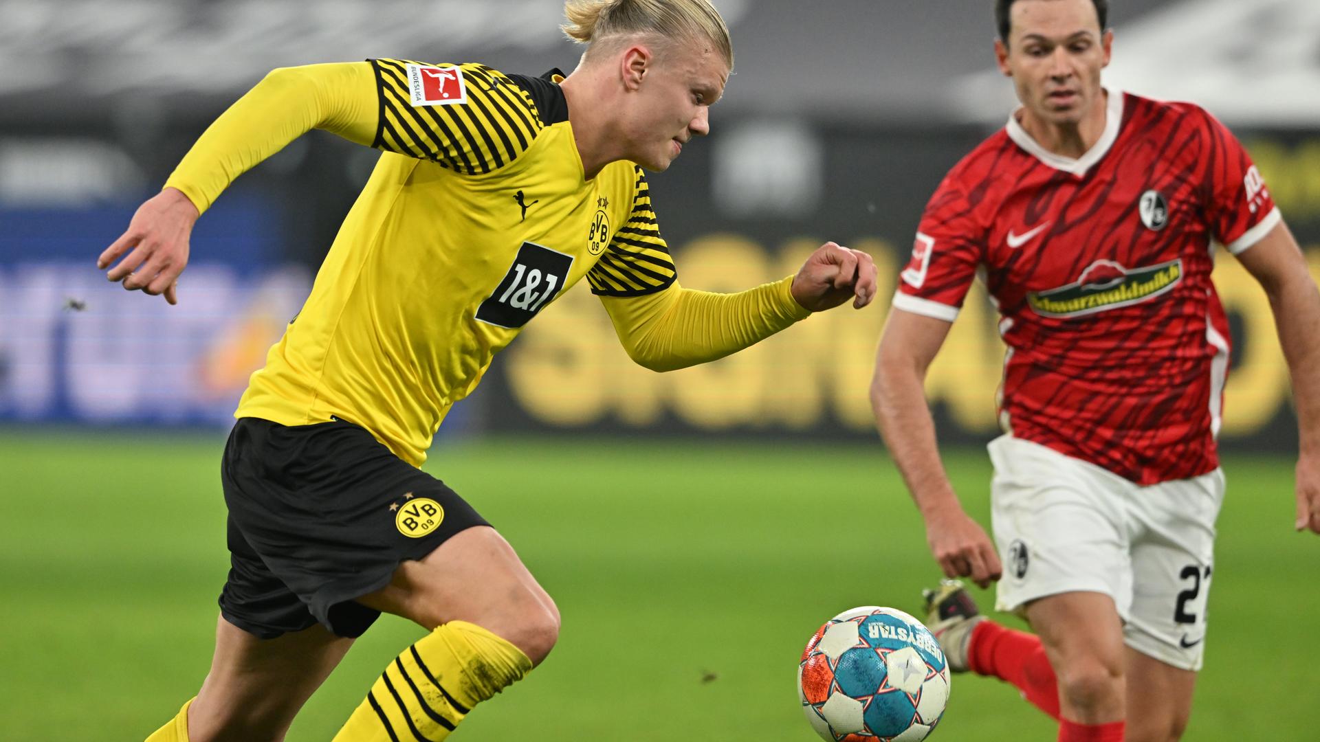 Das Bild zeigt einen Zweikampf beim Fußball-Bundesliga-Spiel Borussia Dortmund gegen den SC Freiburg zwischen Erling Haaland und Nicolas Höfler. Das Bild zeigt einen Zweikampf beim Fußball-Bundesliga-Spiel Borussia Dortmund gegen den SC Freiburg zwischen Erling Haaland und Nicolas Höfler.