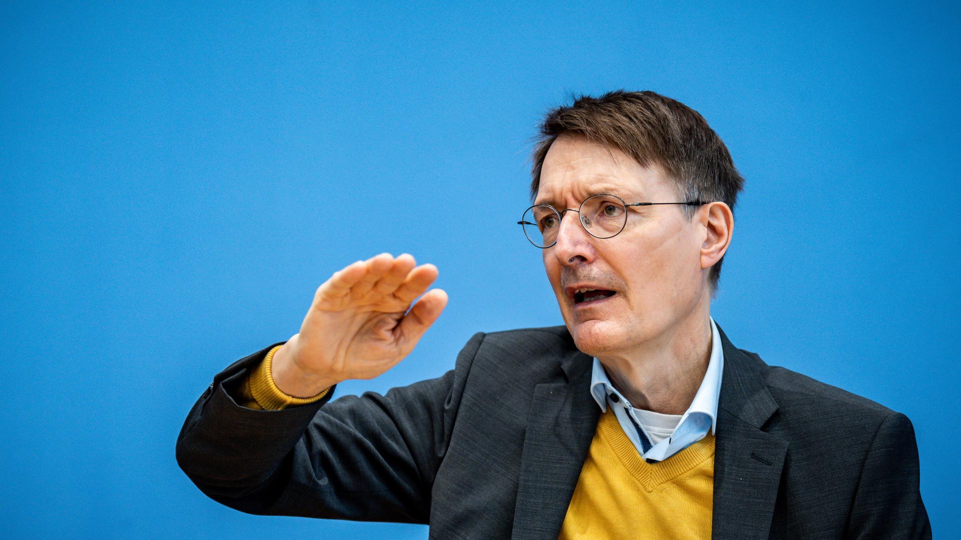 Karl Lauterbach (SPD), Bundesminister für Gesundheit, spricht bei einer Pressekonferenz. Dabei hebt er den rechten Arm. Karl Lauterbach (SPD), Bundesminister für Gesundheit, spricht bei einer Pressekonferenz. Dabei hebt er den rechten Arm.