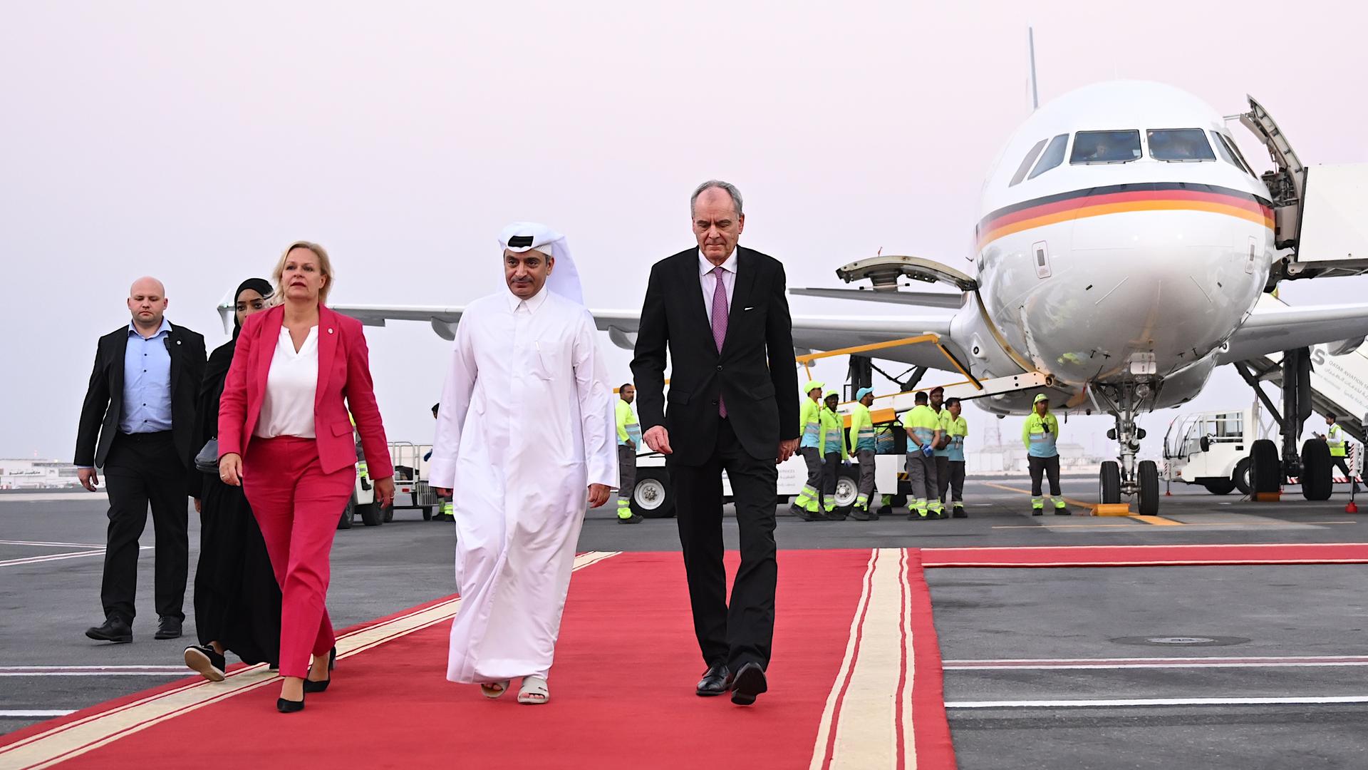 Nancy Faeser wird am Flughafen von Doha empfangen. Sie läuft vom Flugzeug weg über einen roten Teppich.