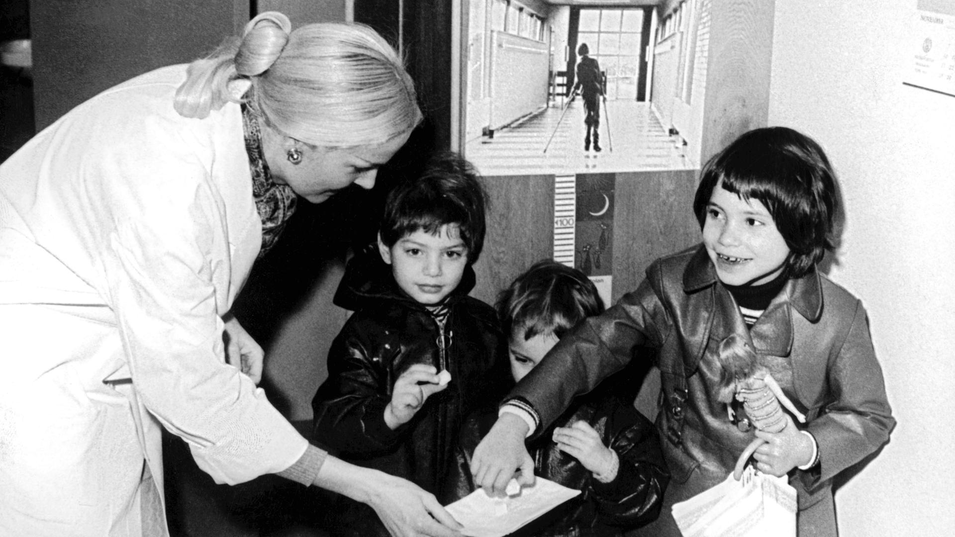 Kinder 1971 vor dem Plakat der bundesweite Impfaktion gegen Kinderlähmung : "Schluckimpfung ist süß, Kinderlähmung ist grausam" 
