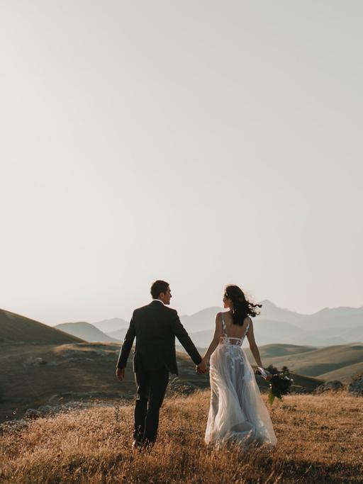 Ein Ehepaar steht vor überwältigender Bergkulisse