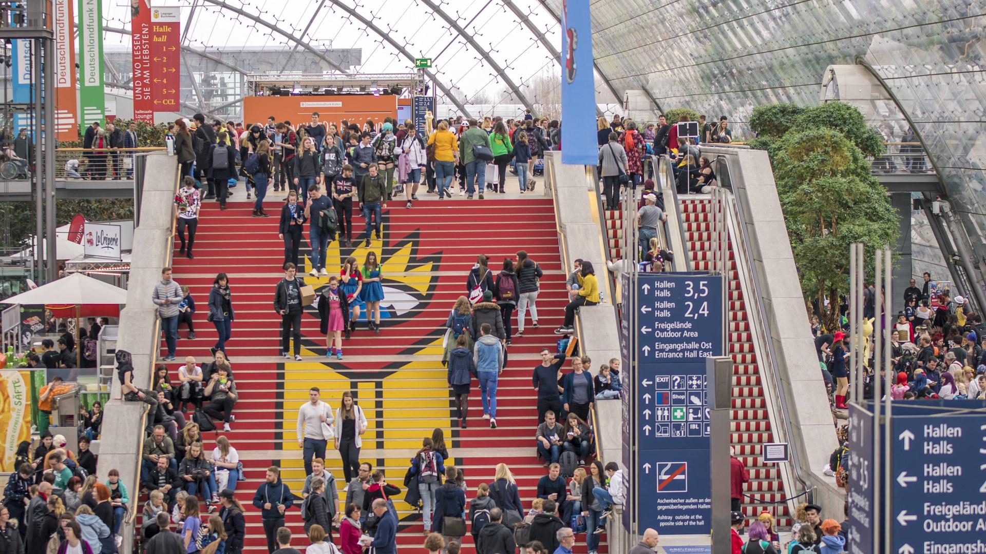 Menschen gehen bei der Leipziger Buchmesse 2019 eine Treppe hoch. Menschen gehen bei der Leipziger Buchmesse 2019 eine Treppe hoch.