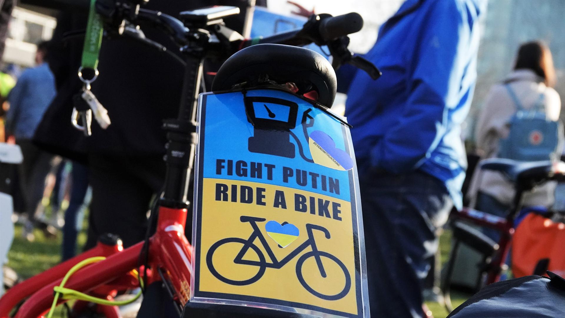 Bei einer Demonstration von "Fridays For Future" in Düsseldorf steht auf einem Schild an einem Fahrrad "Fight Putin Ride A Bike". 