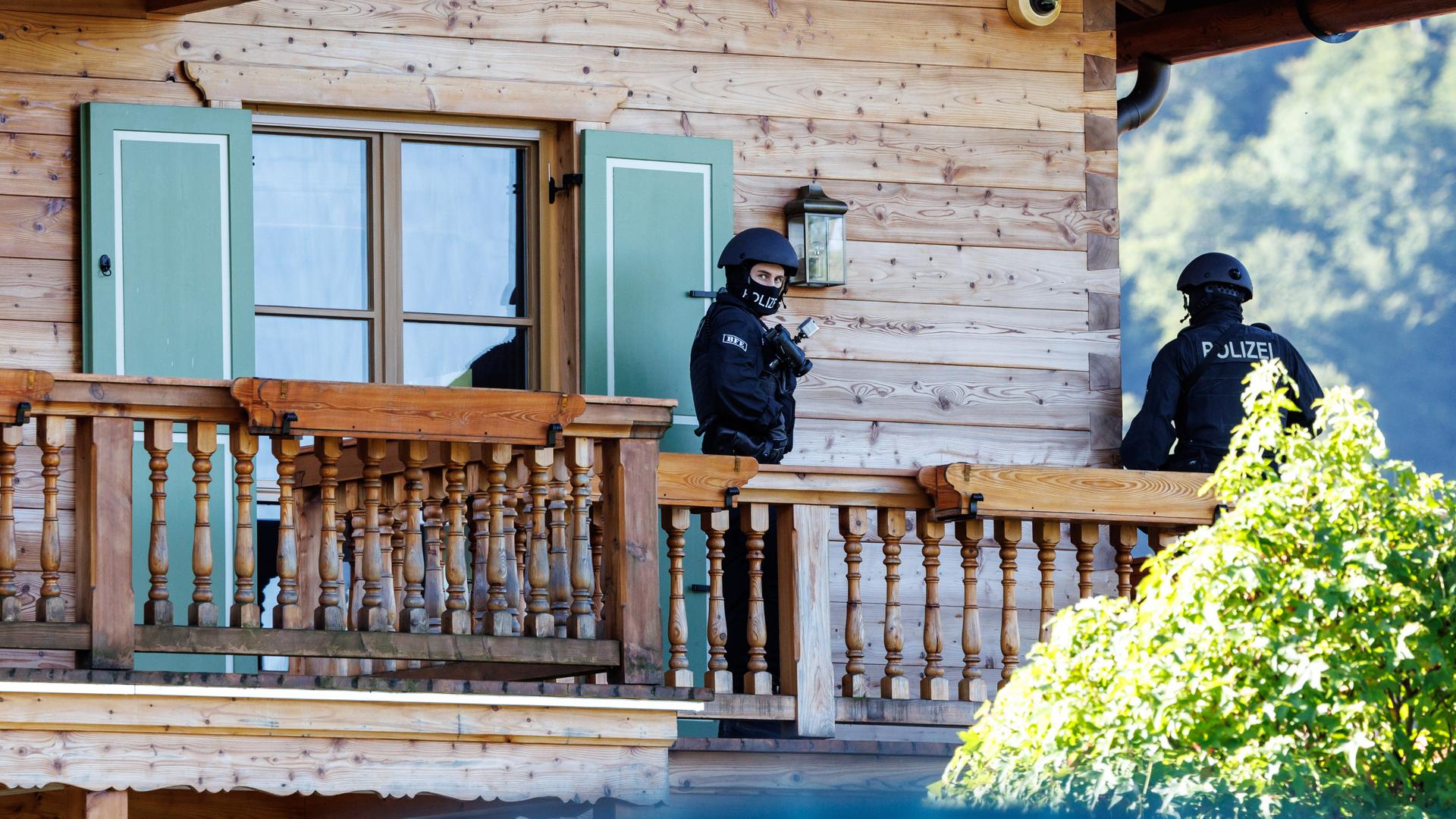 Maskierte Polizisten stehen bei einer Razzia auf einem Balkon von einem Haus des russischen Oligarchen Usmanow. 