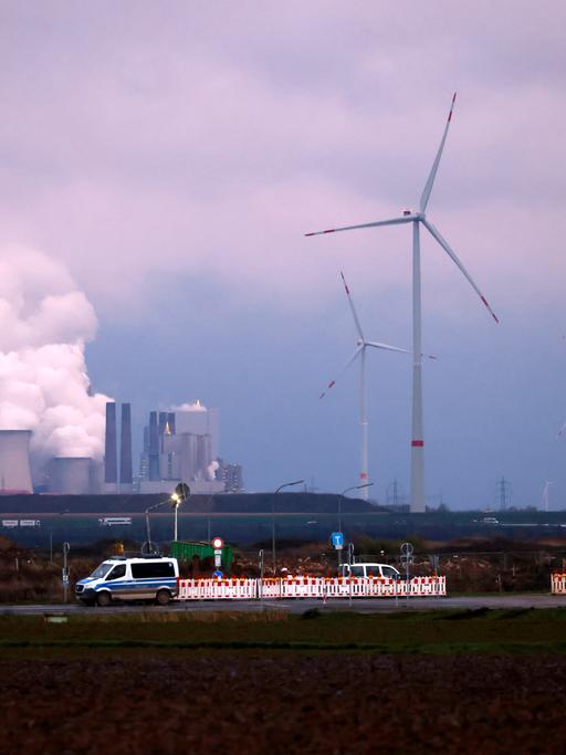 Windkraftanlagen stehen auf einem Feld bei Erkelenz, dahinter das Kohlekraftwerk Neurath von RWE. Die Ampelkoalition hat den Ausbau erneuerbarer Energien beschlossen. Danach sollen bis 2030 mindestens 11,5 Gigawatt aus Windenergie produziert werden. 02.01.2023