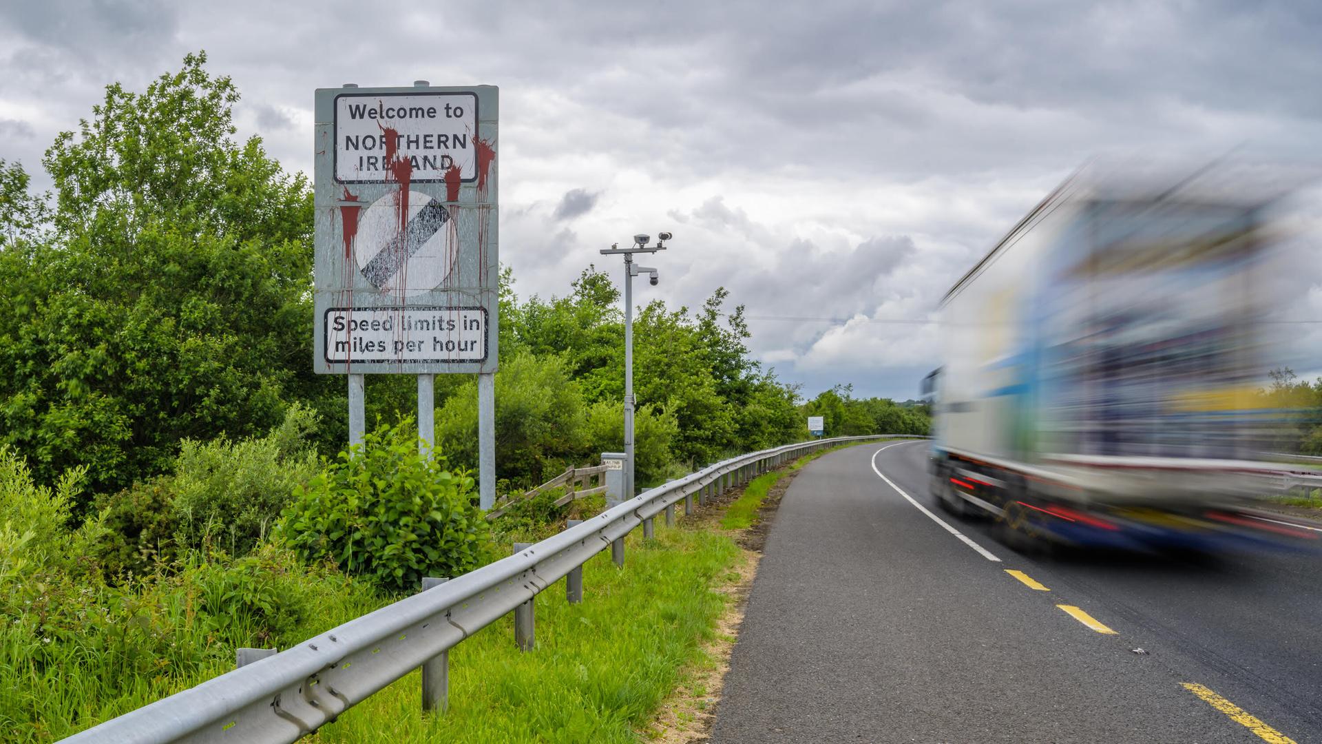 (220614) -- BELFAST, June 14, 2022 (Xinhua) -- A vehicle moves past a border sign near Newry, Northern Ireland, the United Kingdom, on June 14, 2022. The United Kingdom (UK) on Monday introduced a bill to change parts of the Northern Ireland Protocol, a post-Brexit trade deal, while the European Union (EU) said unilateral action is damaging to mutual trust and threatened legal action. TO GO WITH "Roundup: UK reveals plan to change N. Ireland Protocol as EU threatens legal action " (Photo by Colum Lynch/Xinhua)