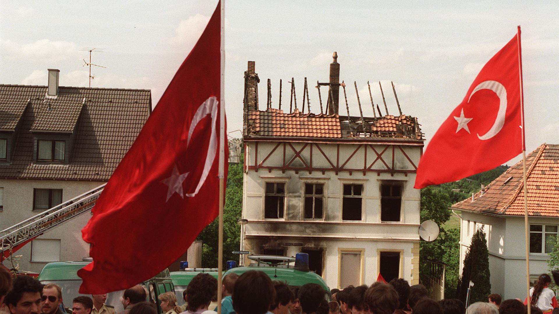 Demonstranten trugen am 29. mai 1993 vor dem ausgebrannten Haus der Familie Genc in Solingen türkische Fahnen. 
