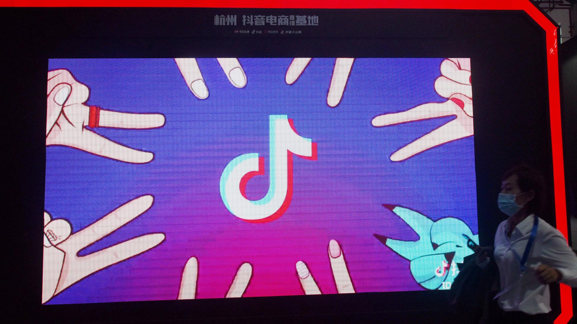 Ein Mensch geht an einem Tiktok-Stand auf einer Messe in Hongkong vorbei, 2021. Ein Mensch geht an einem Tiktok-Stand auf einer Messe in Hongkong vorbei, 2021.