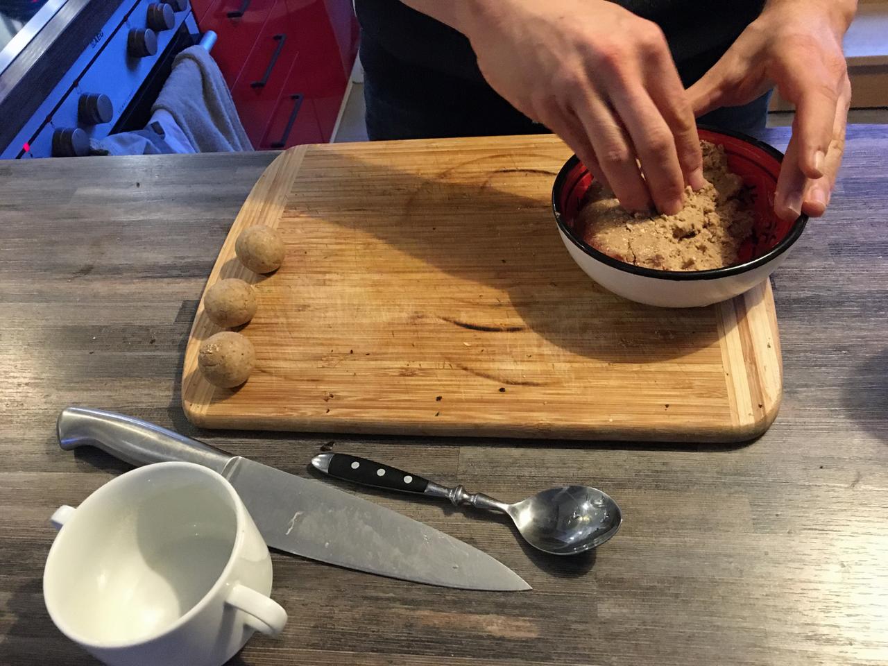 Two hands forming small matzo dumplings Two hands forming small matzo dumplings