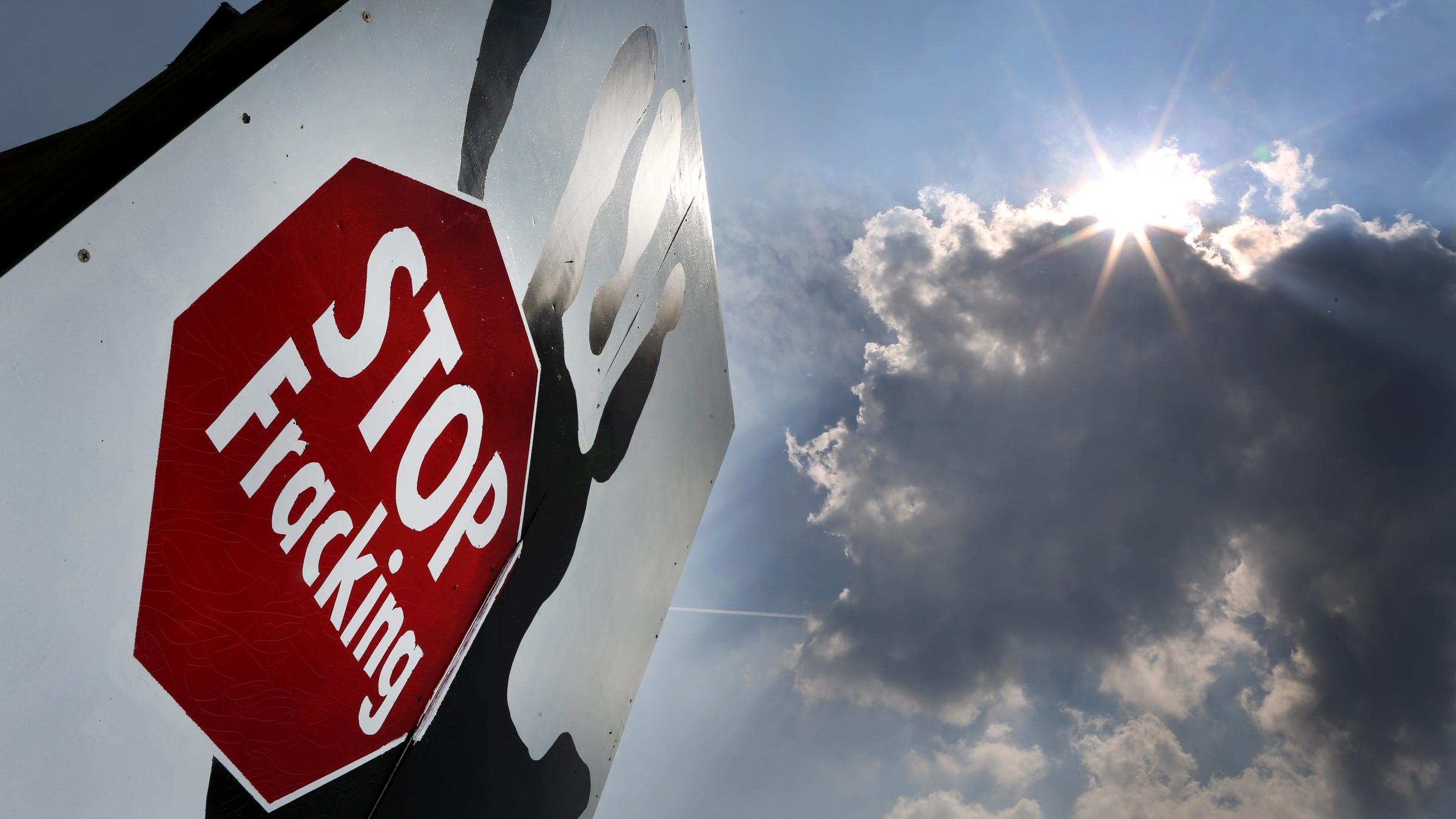 Ein Plakat mit der Aufschrift «Stop Fracking» vor einem bewölkten Himmel