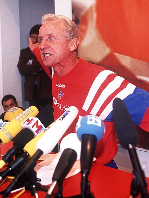 Der Fußballtrainer Giovanni Trapattoni gestikuliert bei seiner legendären Wutrede aufgeregt vor vielen Mikrofonen.