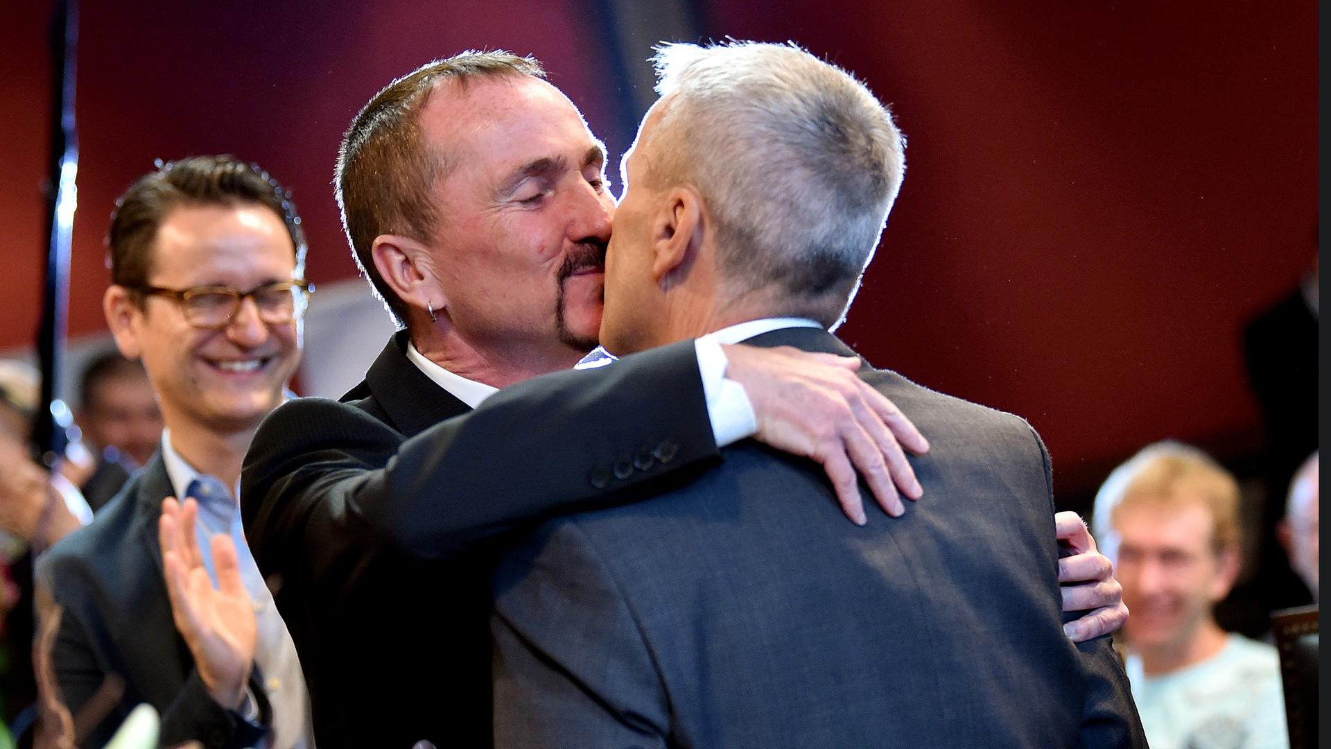 Karl Kreile (l) and Bodo Mende küssen sich nach ihrer Verpartnerung im Rathaus Schoeneberg  in Berlin
