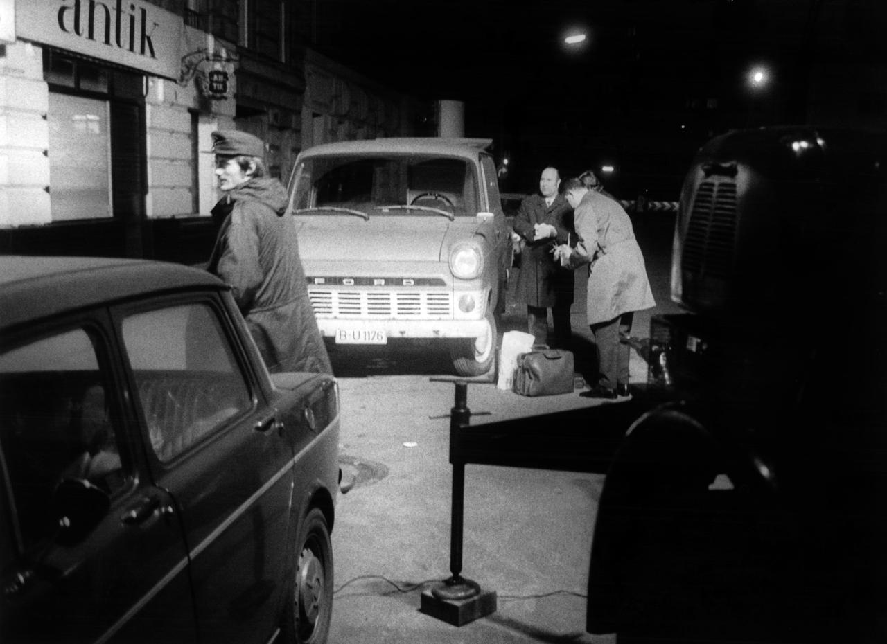 An einer nächtlichen Straße in Berlin im Dezember 1971 stehen Polizisten neben geparkten Autos. An einer nächtlichen Straße in Berlin im Dezember 1971 stehen Polizisten neben geparkten Autos.