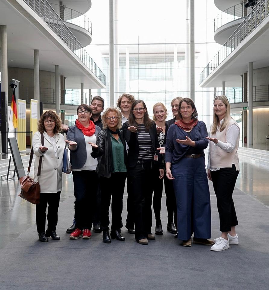 Eine Gruppe Frauen hat sich zum Foto aufgestellt. Sie strecken ihre Hände Richtung Kamera. Eine Gruppe Frauen hat sich zum Foto aufgestellt. Sie strecken ihre Hände Richtung Kamera.