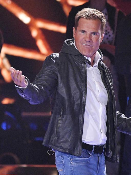 Der Musikproduzent Dieter Bohlen beim Finale der 16. Staffel der RTL-Castingshow "Deutschland sucht den Superstar". Er trägt eine dunkle Lederjacke über einem weißen Hemd und hält eine Siegertrophäe in der Hand.
