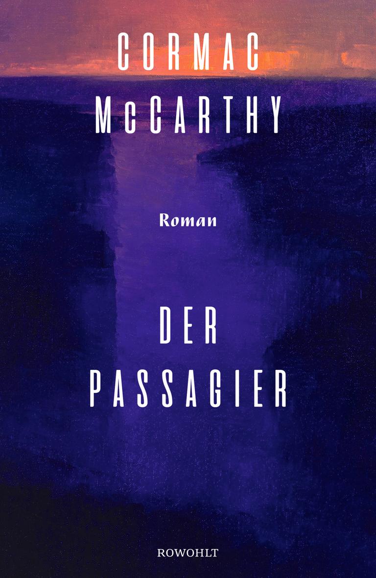 Das Buchcover von Cormac McCarthys Roman "Der Passagier" zeigt den Titel vor dem Hintergrund einer violetten nächtlichen Küstenlandschaft.