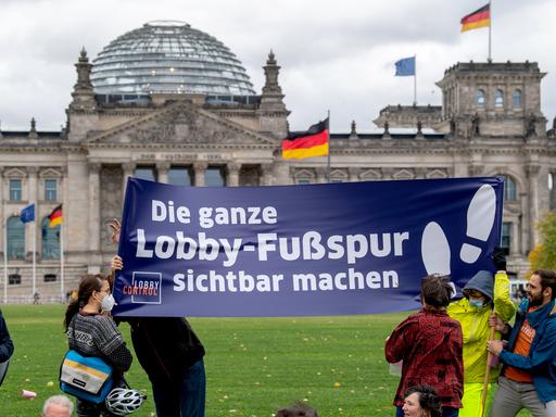 Aktivisten zeigen ein Banner des Vereins LobbyControl auf dem Platz der Republik vor dem Reichstagsgebäude mit der Aufschrift: "Die ganze Lobby-FuÃspur sichtbar machen". Mit der Aktion soll deutlich werden, wie groÃ der Einfluss von Lobbyakteuren ist. Es wird gefordert, dass diese nicht länger verborgen bleiben und dass das Thema Lobbykontrolle im Koalitionsvertrag der nächsten Bundesregierung festgesetzt wird. Die Parteien SPD, Bündnis 90/Die Grünen und FDP treffen sich am selben Tag zu Koalitionsverhandlungen nach der Bundestagswahl. 21.10.2021