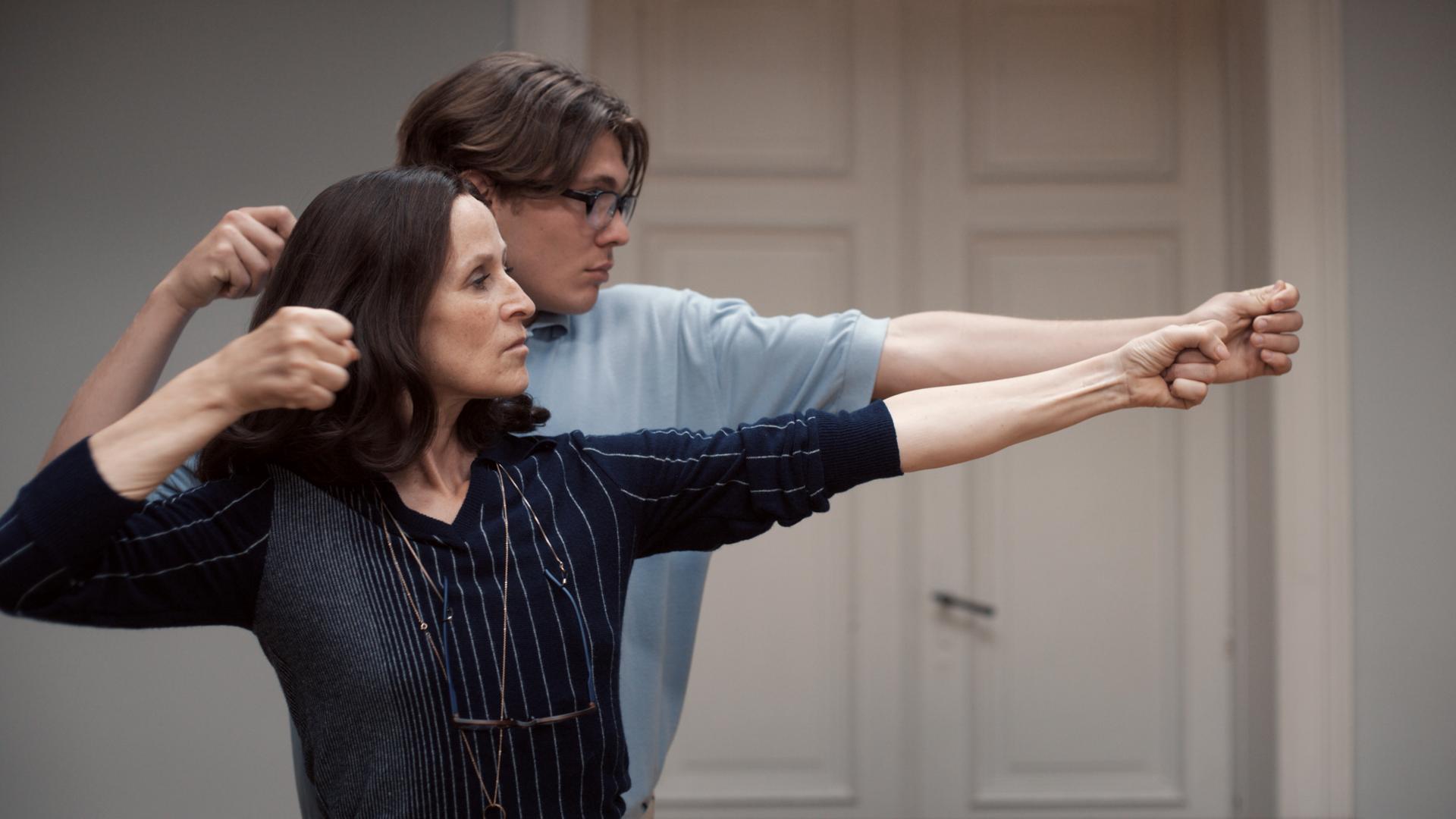 Sophie Rois und Milan Herms spannen in einer Filmszene zusammen einen imaginären Bogen.