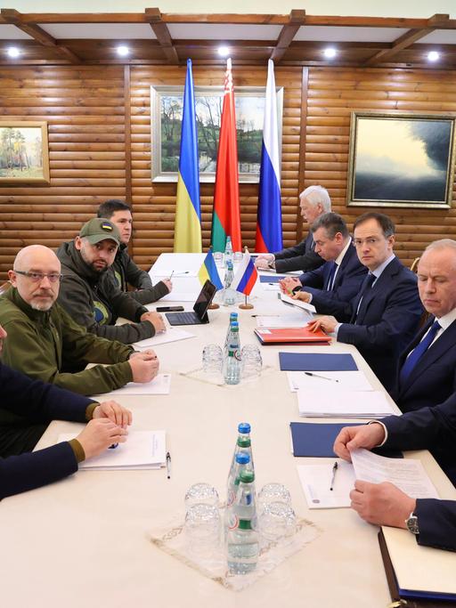 Vertreter der Ukraine (links) und Russlands sitzen an einem Verhandlungstisch in der Nähe der belarussischen Stadt Brest.