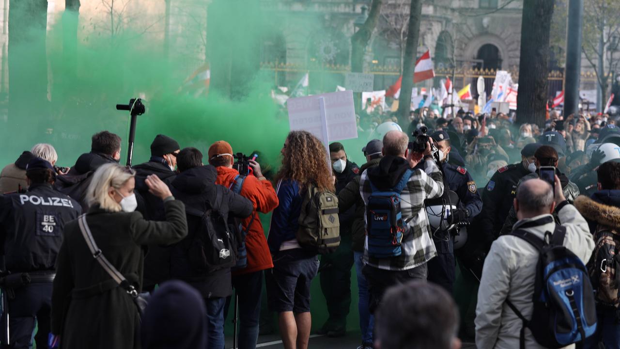 Grüne Rauchschwaden hängen über den Demonstranten einer Demo in Wien gegen die Corona-MaßnahmenRing, 20.11.2021