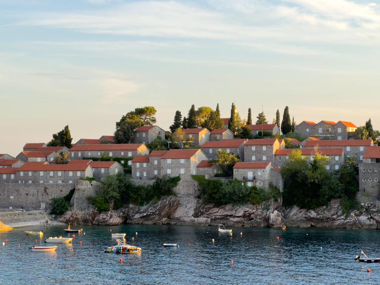 Boote liegen in einer Bucht vor der Küste Montenegros.