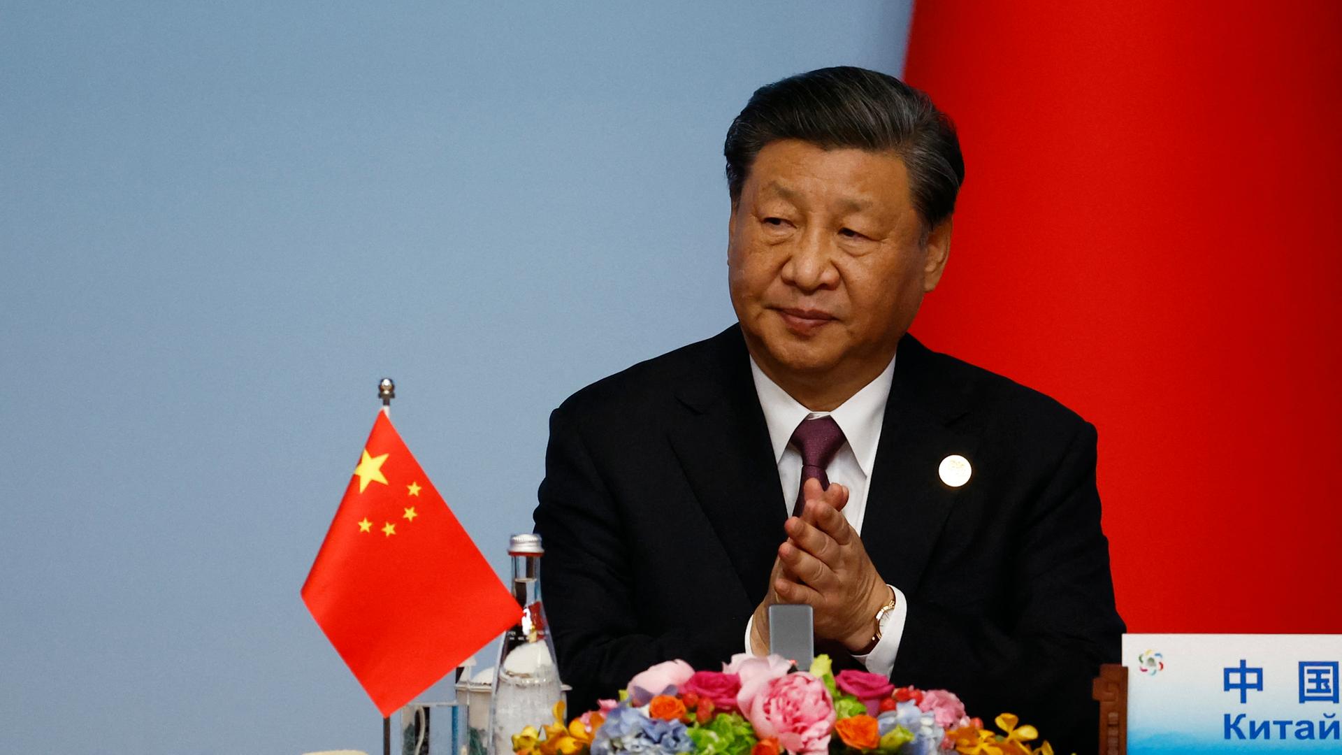 Der chinesische Präsident Xi-Jinping sitzt während des China-Zentralasien-Gipfels an einem Tisch hinter einem Mikrofon. Auf dem Tisch steht eine chinesische Flagge. Der chinesische Präsident Xi-Jinping sitzt während des China-Zentralasien-Gipfels an einem Tisch hinter einem Mikrofon. Auf dem Tisch steht eine chinesische Flagge.