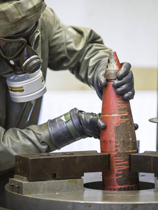 Mitarbeiter der Gesellschaft zur Entsorgung von chemischen Kampfstoffen und Rüstungsaltlasten, GEKA, bereiten eine Chemiewaffen-Granate zur Delaborierung - trennen von Sprengstoff und Kampfstoff - vor.
