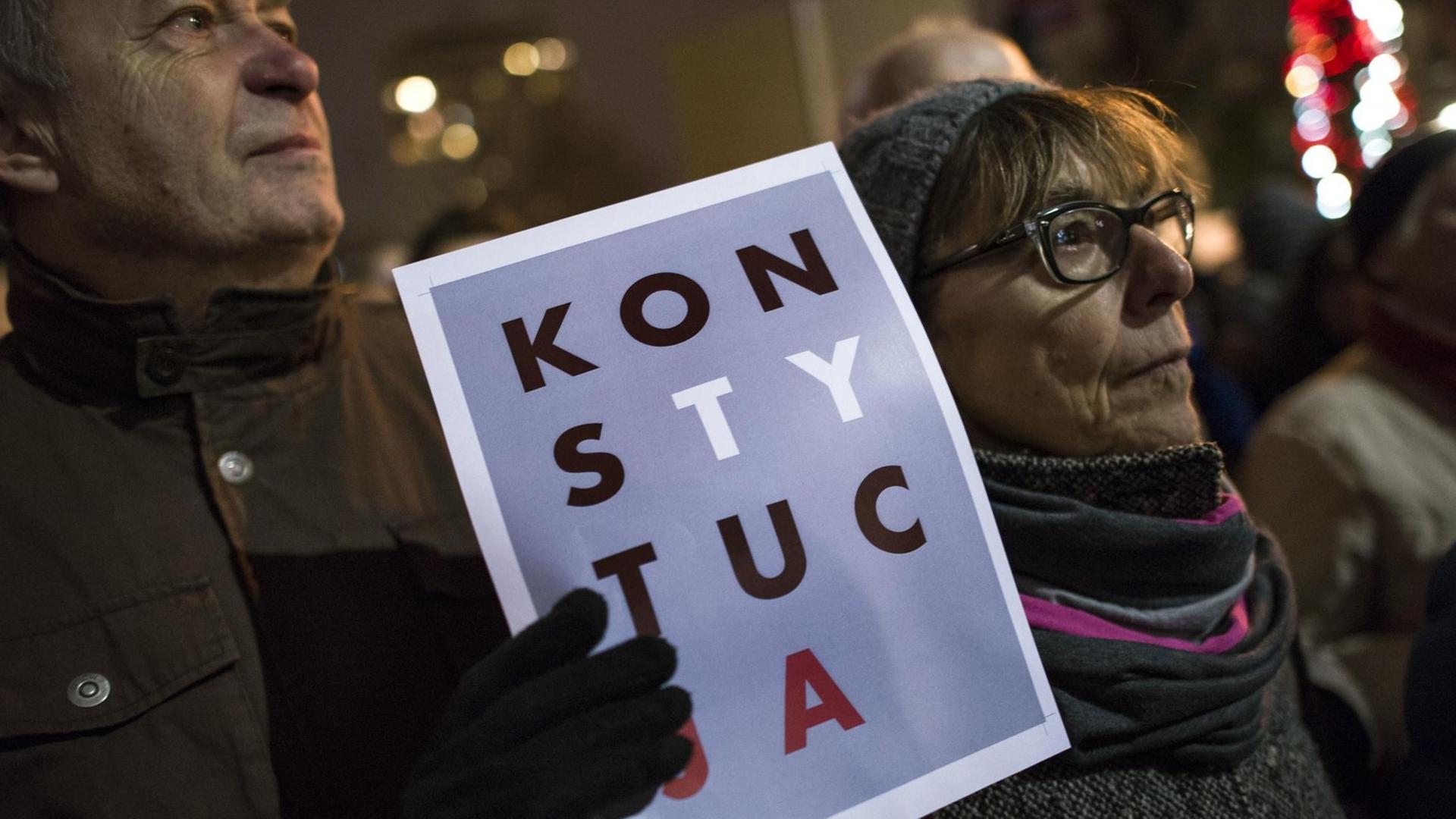 December 18, 2019, Warsaw, Poland: A protester holds a placard saying Constitution during the demonstration..Thousands of people protested outside the Parliament and in 130 cities across Poland. Protests were held under the slogan ''Today judges, you tomorrow''. The protests concern the draft amendment to the law on common courts and the Supreme Court which provides for the possibility of disciplining judges and dismissing them from the profession those who will challenge the actions of the new National Council of the Judiciary or other judges. Law and Justice (PiS) MPs who submitted this bill to the Polish Sejm (Parliament) also want to reduce the independence of the Supreme Administrative Court. If the new regulations come into force, it's the President, and not the general assembly of judges of the Supreme Administrative Court will decide on the internal system of the court. (Credit Image: © Attila Husejnow/SOPA Images via ZUMA Wire | December 18, 2019, Warsaw, Poland: A protester holds a placard saying Constitution during the demonstration..Thousands of people protested outside the Parliament and in 130 cities across Poland. Protests were held under the slogan ''Today judges, you tomorrow''. The protests concern the draft amendment to the law on common courts and the Supreme Court which provides for the possibility of disciplining judges and dismissing them from the profession those who will challenge the actions of the new National Council of the Judiciary or other judges. Law and Justice (PiS) MPs who submitted this bill to the Polish Sejm (Parliament) also want to reduce the independence of the Supreme Administrative Court. If the new regulations come into force, it's the President, and not the general assembly of judges of the Supreme Administrative Court will decide on the internal system of the court. (Credit Image: © Attila Husejnow/SOPA Images via ZUMA Wire |