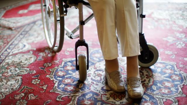 Die Beine einer 97-jährigen Seniorin, die in einem Rollstuhl sitzt.